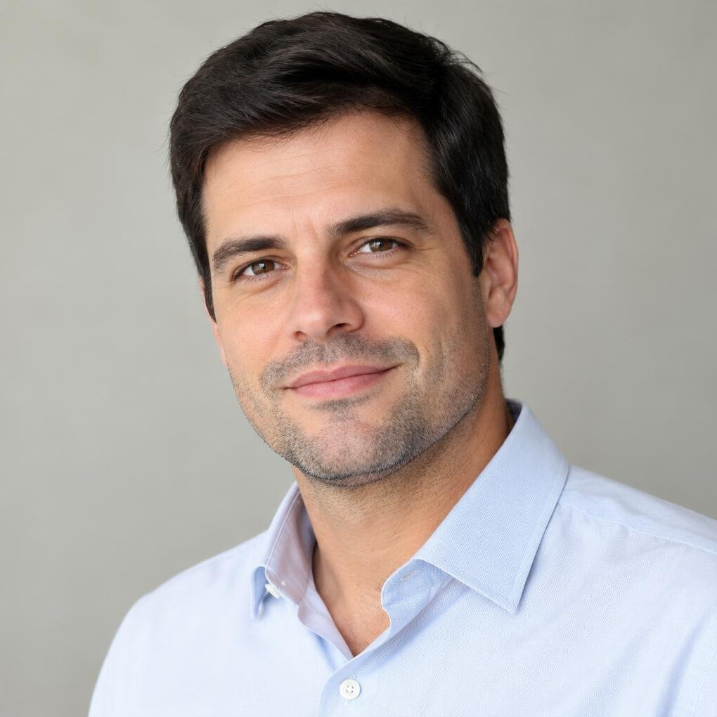 Portrait of a man with short hair and a slight smile