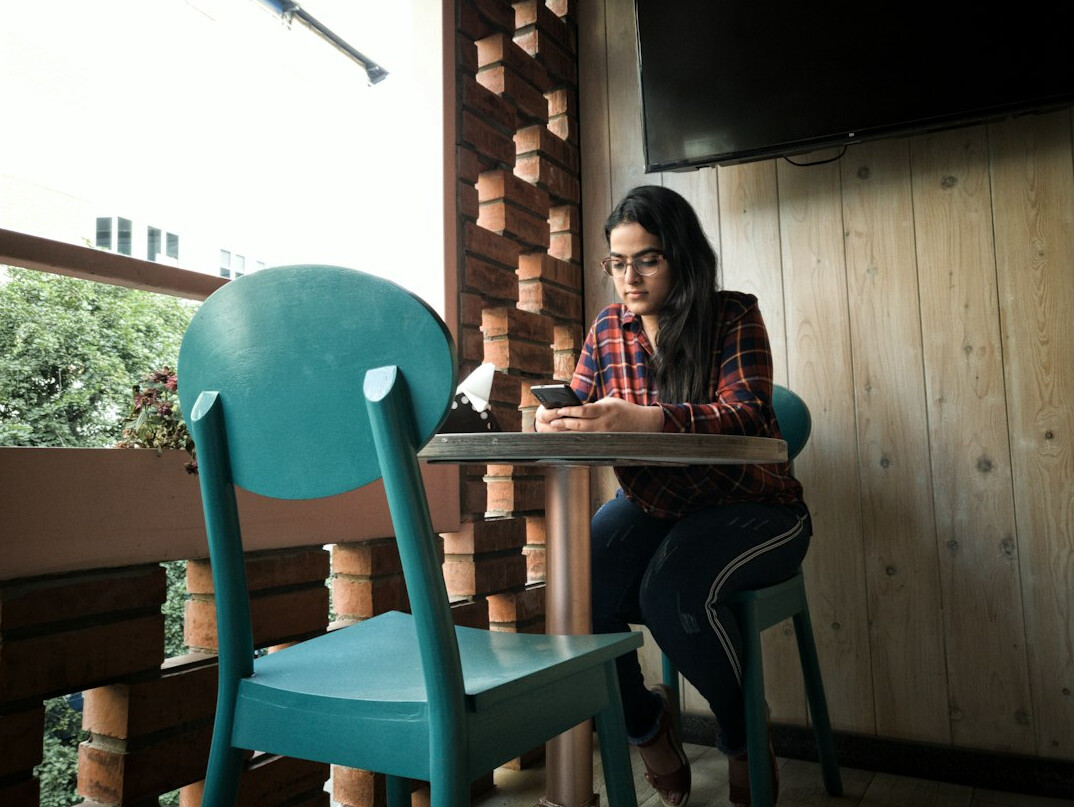 person journaling in cafe